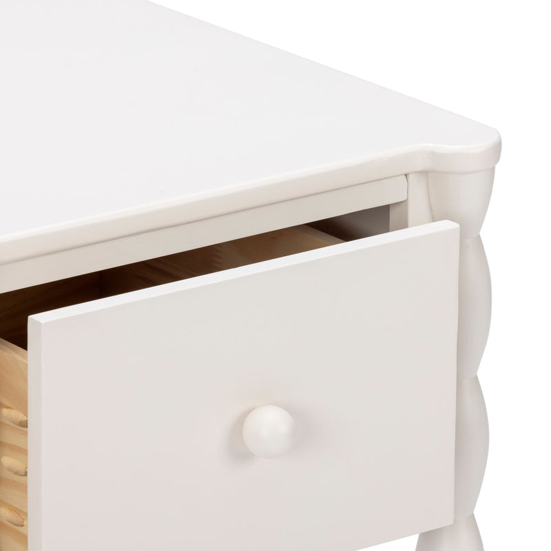 White wooden nightstand with one open drawer, round knob and turned leg detail — cottage-style bedroom storage