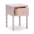Blush pink wooden nightstand with single pull-out drawer, turned spindle legs and round knob, stylish bedside table for nursery or bedroom