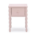 Pastel pink painted wood bedside table with single drawer and turned spindle legs, modern nursery nightstand