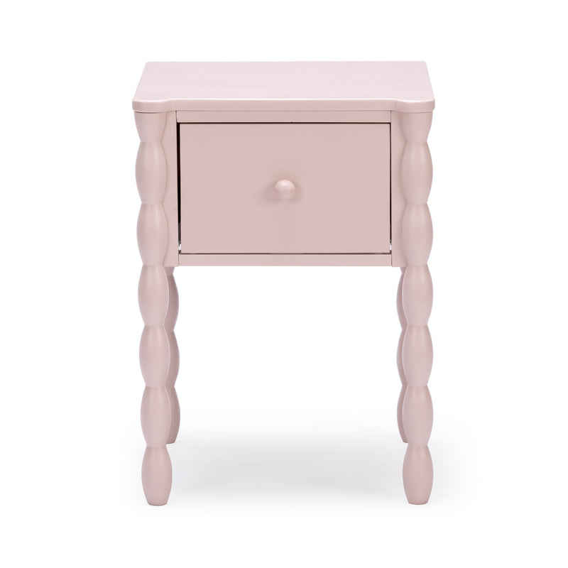 Pastel pink painted wood bedside table with single drawer and turned spindle legs, modern nursery nightstand