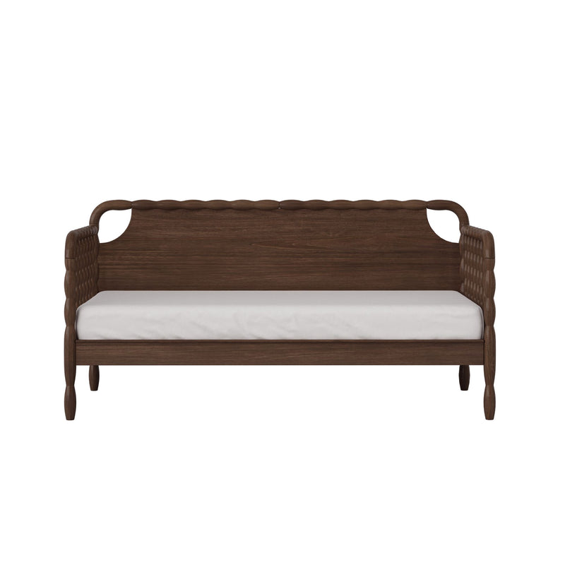 Dark walnut wood daybed with woven rattan arms, scalloped carved backrest, turned legs and white mattress, vintage farmhouse seating