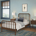 Cozy kids bedroom with wooden spindle bed, blue walls, plaid rug, matching nightstands and lamps, stuffed toys, window with brown blinds and nautical wall art
