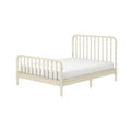 Ivory wooden spindle bed frame with turned headboard and footboard and white mattress, vintage-inspired bedroom furniture on white background