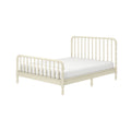 Ivory spindle bed frame with turned wooden headboard and footboard and white mattress, farmhouse-style bedroom furniture