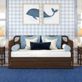 Coastal nursery bedroom with wooden daybed, blue and white pillows and navy whale framed prints on gray gingham wallpaper