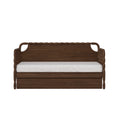 Dark walnut wood daybed with woven rattan armrests and white mattress, rustic boho sofa bed for living room or guest room
