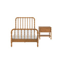 Solid oak spindle bed frame with white bedding and matching wooden nightstand in natural finish, classic farmhouse bedroom furniture