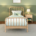 Children's bedroom with wooden spindle bed, mint green wainscoting, striped bedding, plush octopus toy and bedside lamp