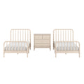 Neutral cream wooden twin beds with spindle headboards flanking a matching beige three-drawer dresser in a minimalist nursery or kids' bedroom