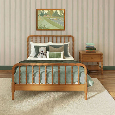 Cozy children's bedroom interior with wooden spindle bed, green bedding, teddy bear on pillows, striped wallpaper, framed painting and nightstand with stacked books