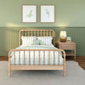 Cozy green nursery bedroom with wooden spindle bed, mint striped bedding, plush octopus pillow, coastal wall art and wicker nightstand lamp