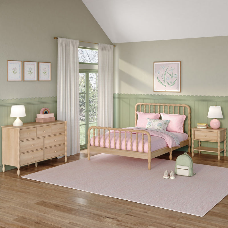 Pastel green and pink girls' bedroom with wooden spindle bed, natural wood dresser, scalloped wainscoting, cream curtains and soft pink bedding
