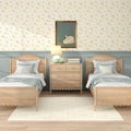 Twin bedroom with light wood beds, floral wallpaper, framed swan art, bedside lamp, mint accent decor