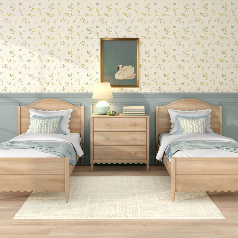 Twin bedroom with light wood beds, floral wallpaper, framed swan art, bedside lamp, mint accent decor