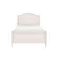 White wooden bed frame with arched headboard, scalloped apron and turned legs on a minimalist background