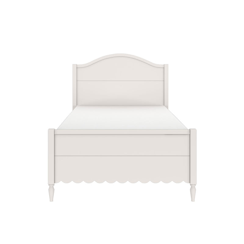White wooden bed frame with arched headboard, scalloped apron and turned legs on a minimalist background