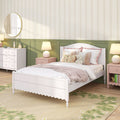 Cozy girl's bedroom with white bed, pink nightstands, floral pillows and teddy bear against green wainscoting and striped floral wallpaper