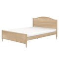 Light wood bed frame with arched headboard, scalloped footboard, turned legs and white mattress — minimalist farmhouse wooden bed