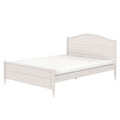 White wooden bed frame with curved headboard, scalloped footboard and turned legs, platform-style mattress support, farmhouse bedroom furniture