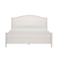 White painted wooden bed frame with arched headboard, scalloped skirt and turned legs, front view bedroom furniture