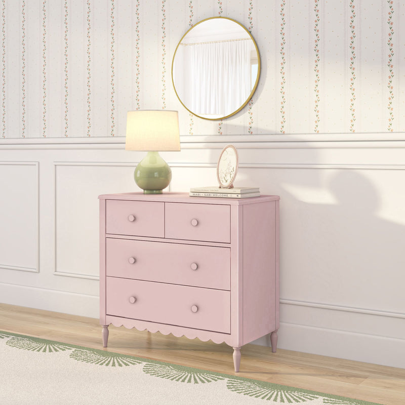 Pink vintage dresser with green ceramic lamp and round gold mirror against floral striped wallpaper — pastel nursery bedroom decor
