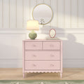 Pastel pink dresser topped with a green ceramic table lamp, gold round mirror and oval frame against floral striped wallpaper and white wainscoting on light wood floor