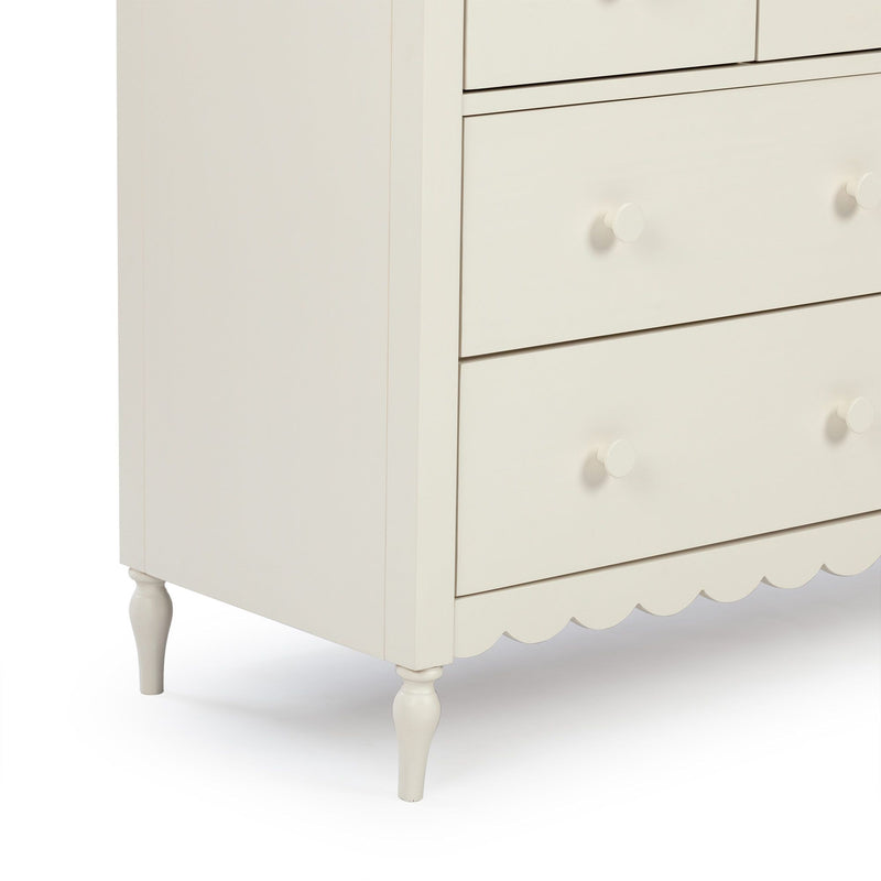 Cream white wooden dresser with drawers and round knob pulls, scalloped apron and turned legs — classic bedroom nursery storage chest
