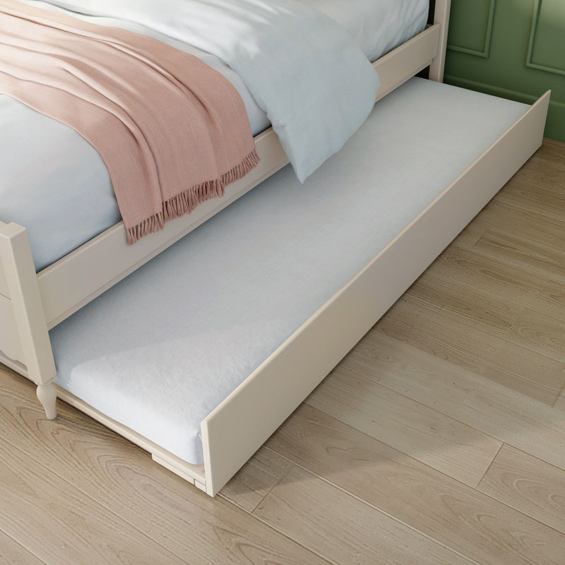 White twin trundle bed with light blue sheets and pink throw blanket on hardwood floor by green accent wall — space-saving bedroom furniture