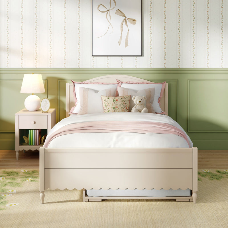Children's pastel bedroom with white bed, pink bedding, floral throw pillow, teddy bear, green wainscoting, bedside lamp and ribbon wall art
