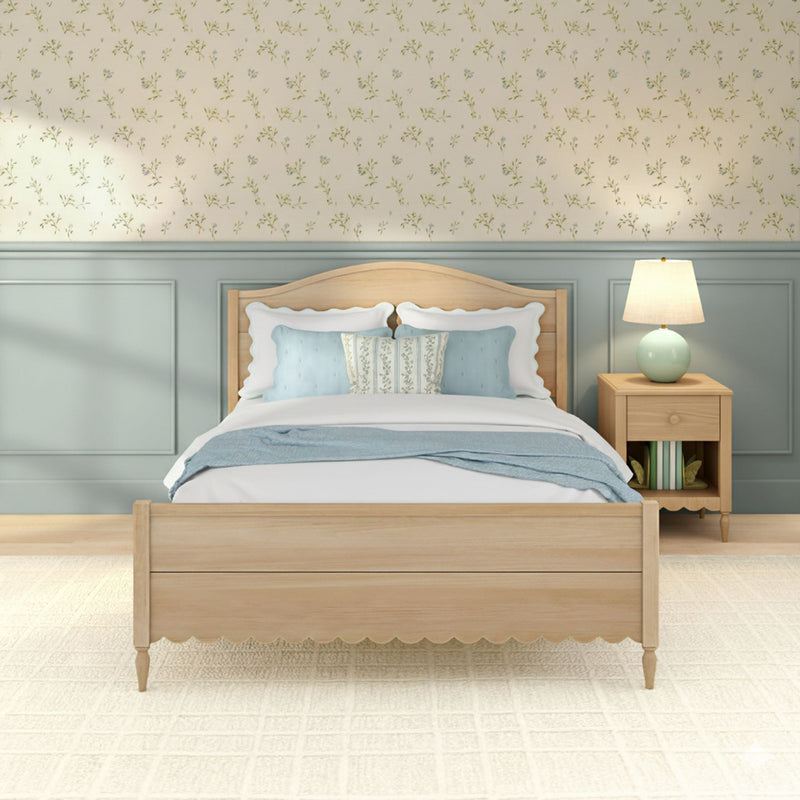 Cozy farmhouse bedroom with light wood bed, pastel blue bedding, delicate floral wallpaper, blue-gray wainscoting and bedside lamp