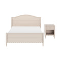 Beige wooden bed frame with arched headboard, scalloped trim and turned legs paired with matching bedside nightstand
