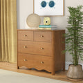 Mid-century modern oak dresser with brass knobs, paper lantern table lamp and yellow instant camera on stacked books, framed sunglasses art, potted bamboo and mustard curtains