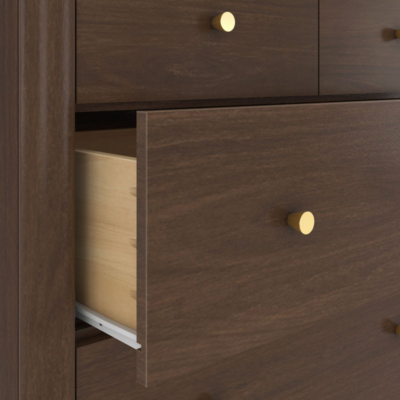 Close-up of partially open walnut dresser drawer with gold round knobs, visible metal drawer slide and light wood interior, modern bedroom storage furniture