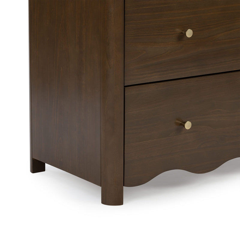 Close-up of dark walnut dresser drawers with brass knob, visible wood grain and scalloped apron for modern bedroom storage