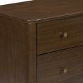 Close-up of dark brown wooden dresser drawer showing smooth rounded top edge, rich wood grain finish and brass round knob