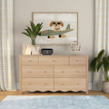 Light wood dresser with drawers topped by framed airplane puppy wall art, potted plant, Nintendo Switch dock and headphones — modern children's bedroom decor