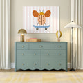 Nursery wall art: whimsical orange ladybug on a blue skateboard on a pastel pink-striped canvas above a teal dresser, children's room decor