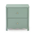 Sage green matte painted wooden bedside nightstand with two drawers, brass knob, rounded corners and scalloped apron, modern vintage bedroom table