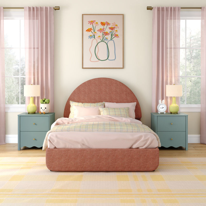 Pastel modern bedroom interior with rounded terracotta upholstered headboard, pink and yellow bedding, sheer pink curtains, teal nightstands with yellow lamps and playful decor, framed floral wall art, and natural light