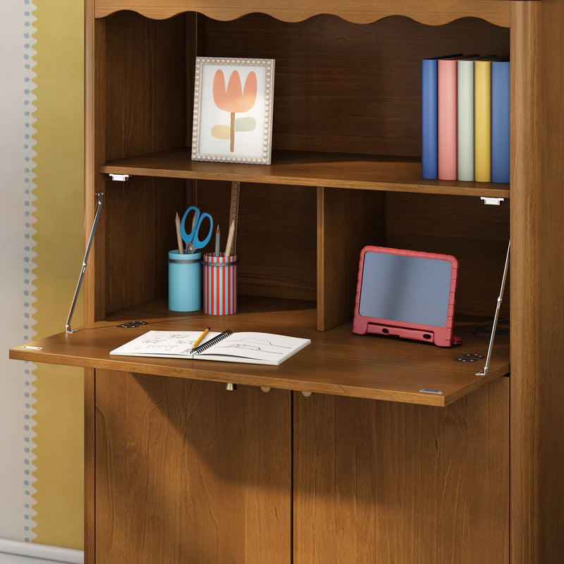 Wooden fold-down kids desk showing tablet in red case, colorful books, pencil cups with scissors, framed tulip print and open notebook with pencil