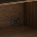 Dark walnut wood paneling with a built-in black power outlet featuring dual AC sockets and USB charging ports