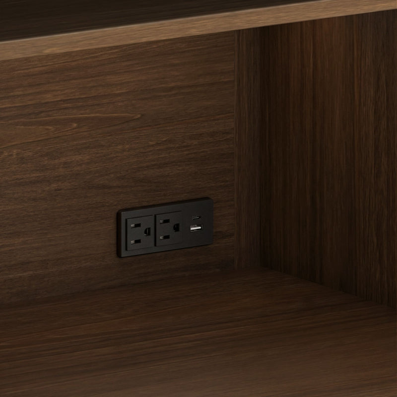 Dark walnut wood paneling with a built-in black power outlet featuring dual AC sockets and USB charging ports