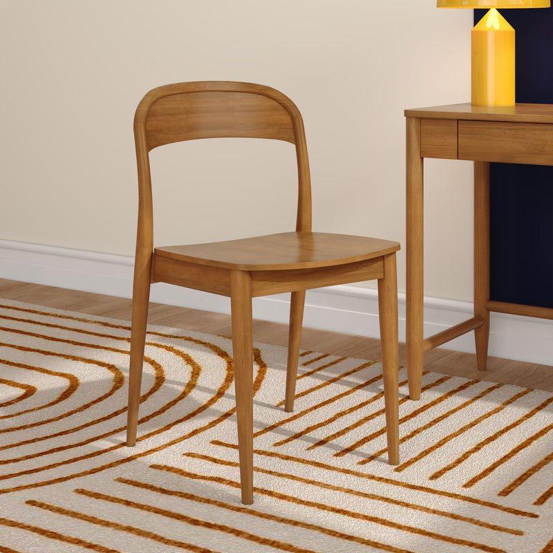 Scandinavian natural wood chair beside matching wooden desk on beige wall, orange-striped rug and yellow table lamp — modern minimalist interior