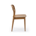 Side view of light oak wooden dining chair with curved backrest and tapered legs on white studio background