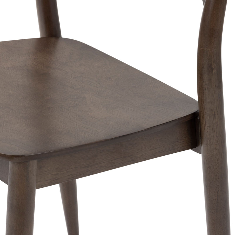 Close-up of solid wood dining chair seat and tapered legs in walnut finish, mid-century modern wooden chair detail