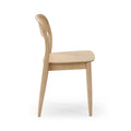 Side view of light oak dining chair with curved backrest and tapered legs, Scandinavian modern wooden chair