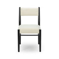 Modern minimalist dining chair with cream upholstered seat and back and black wooden frame, front view on white background