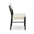 Side view of modern white upholstered dining chair with black metal frame and tapered legs on white background