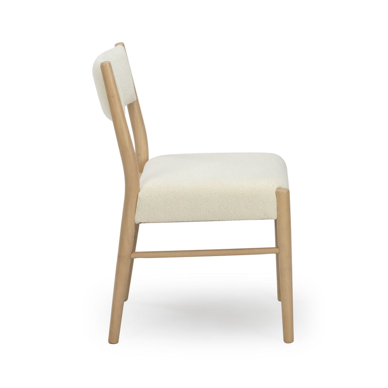 Side view of modern Scandinavian dining chair with cream boucle upholstered seat and back and light oak wooden frame, contemporary kitchen or dining room seating