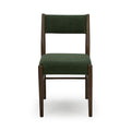 Front view of green upholstered dining chair with dark walnut wood frame on white background, mid-century modern style